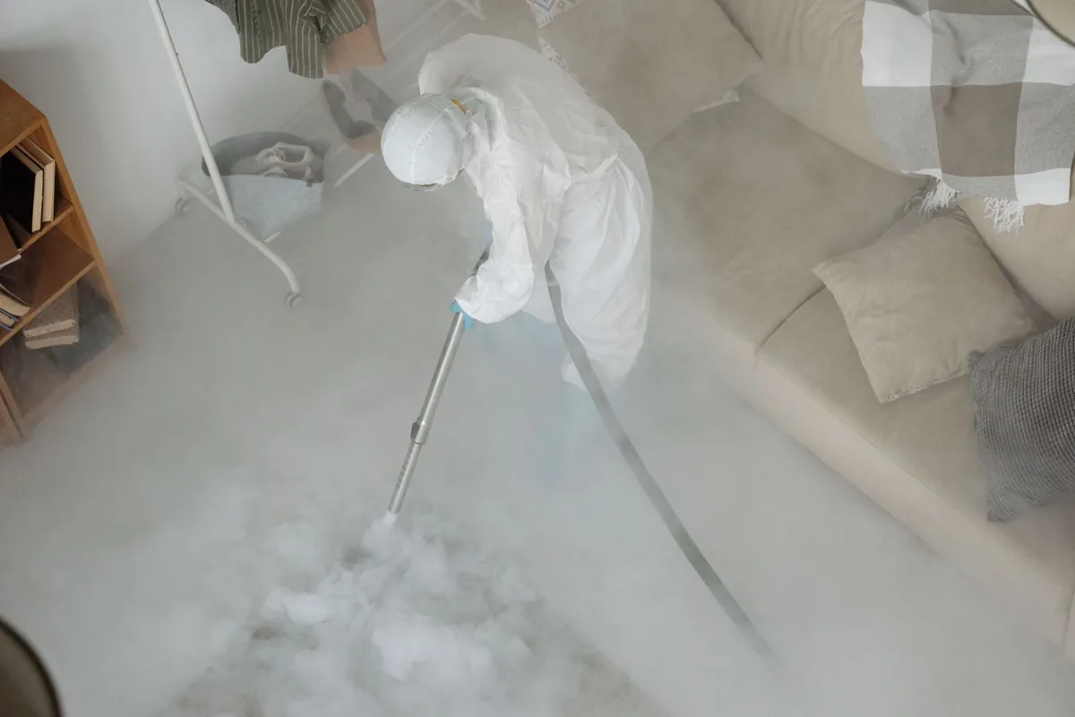 Biohazard cleanup technician in protective equipment, Heathcote, NJ